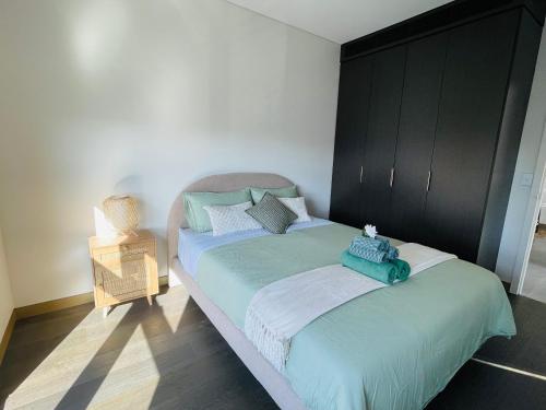 a bedroom with two beds and a night stand at Modern Apartment St Leonards in Sydney