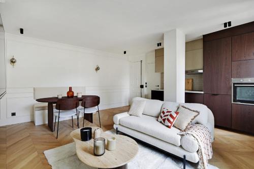 a living room with a couch and a table at VINCENNES Luxury flat L005 in Vincennes