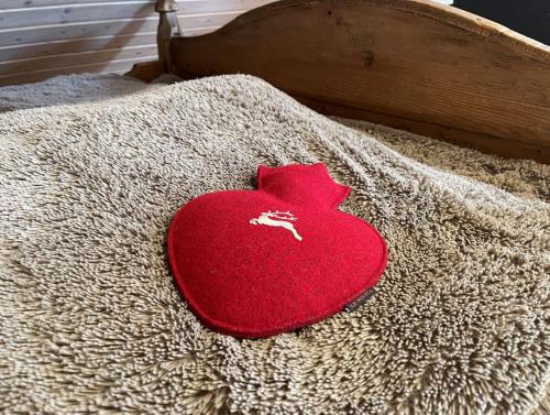 a red heart laying on top of a bed at Alte Villa Traunstein in Traunstein