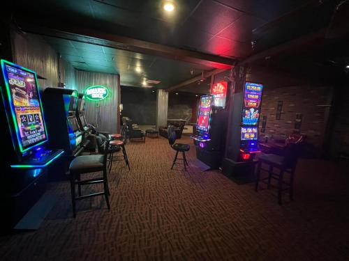 a room with several video game machines and chairs at Travelodge by Wyndham Lincoln Northeast in Lincoln