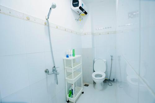 a bathroom with a toilet and a camera on the wall at TINA HOUSE Apartment in Da Nang