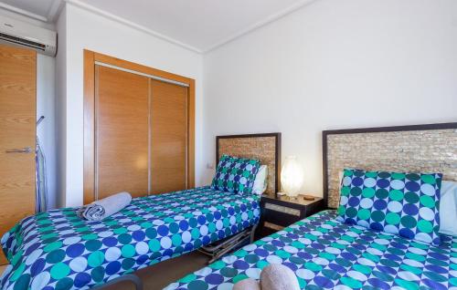 a bedroom with two beds with blue and green at Nice Apartment In Sucina With Wifi in Sucina