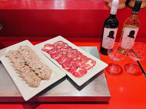a table with two plates of food and two bottles of wine at Hotel Resol Kyoto Kawaramachi Sanjo in Kyoto