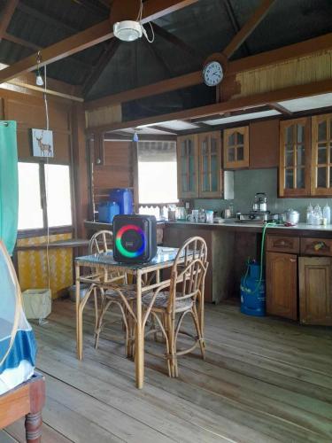 a kitchen with a table with a tv on it at Just Inn2 beachfront in El Nido