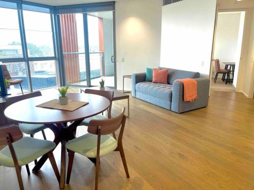a living room with a table and a couch at Sydney City Side Beauty @ Chippendale 1 Bedroom Aircon in Sydney