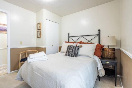 a bedroom with a large white bed and a desk at Spacious 6 BR Extended Stay in North Salt Lake