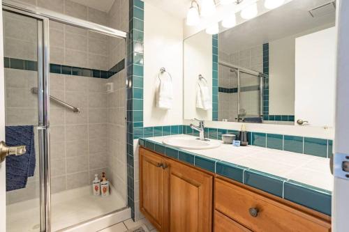 a bathroom with a shower and a sink and a mirror at Spacious 6 BR Extended Stay in North Salt Lake