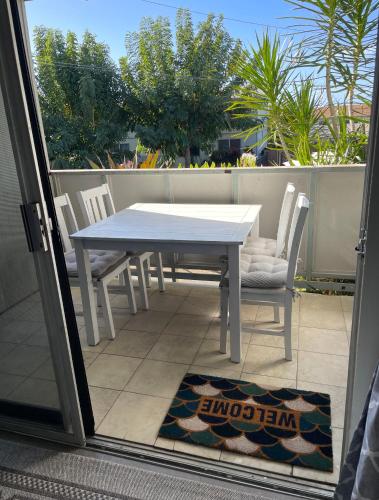 a white table and chairs on a patio at Your Slice of Paradise in Kona - Walk to Beach and Stores in Kailua-Kona