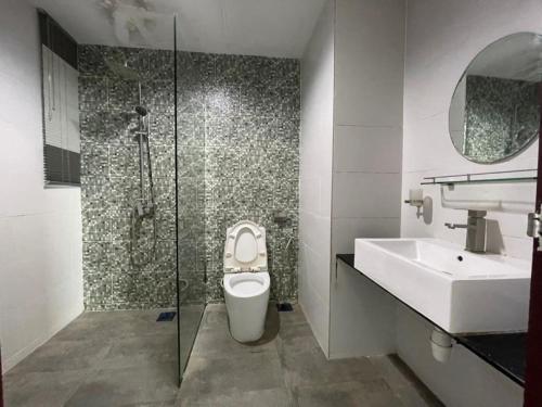 a bathroom with a shower and a toilet and a sink at DS VivacityMall Jazz Suite 3 810 in Kuching