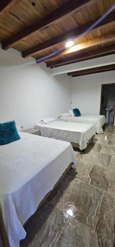 a room with two beds and a stone floor at PUENTE IGLESIA in Montenegro