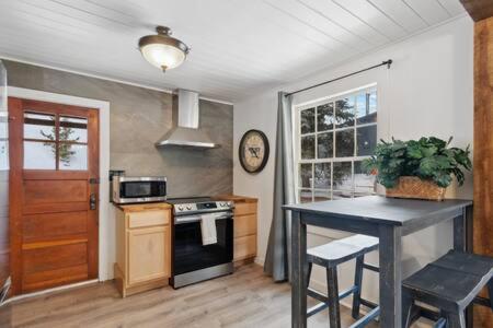 a kitchen with a table and a stove top oven at Blue Spruce Cabin in Allenspark