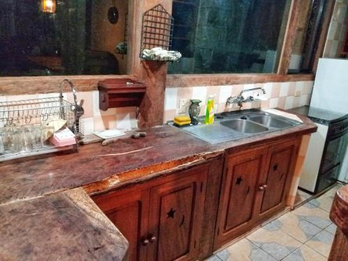 a kitchen with a sink and a counter top at Peña Alta Samaipata in Samaipata