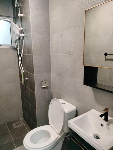 a bathroom with a toilet and a sink at Tamu @ Ostia Bangi in Bangi