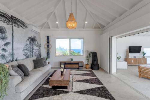 a living room with a couch and a table at Oceanview Luxury Villa Escape in Dawn Beach