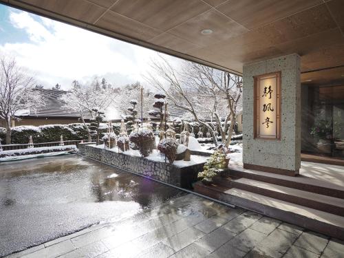 a building with chinese writing on the side of it at Seifutei in Inawashiro