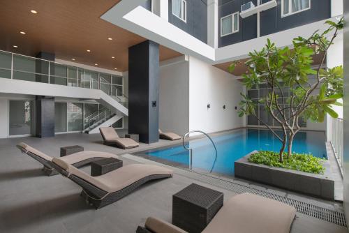 an indoor swimming pool in a building with a house at The Suites at Torre Lorenzo Malate - Managed by The Ascott Limited in Manila