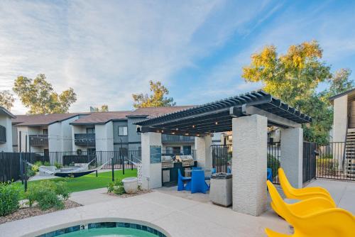 a backyard with a slide and a playground at 2BR near Stone Creek - Pool & Mall Access Comfort - C254 in Phoenix