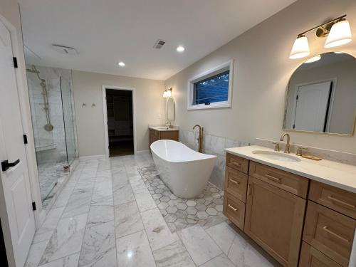 un ampio bagno con vasca e lavandino di New Farmhouse, King Beds, Game Room, Hot Tub & View! a Montgomery