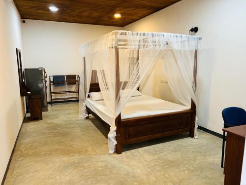 um quarto com uma cama de dossel em Hari Villa Mirissa em Mirissa