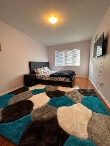 a bedroom with a bed and a large rug at Golden Spring Beautiful home in Brampton