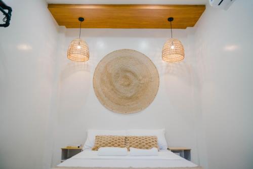 a bedroom with a bed with two lamps and a hat at Private Villa with Pool in Vigan, Ilocos Sur - Selene Private Villas in San Vincente