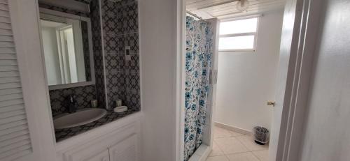 a bathroom with a sink and a mirror at Seaview property Hastings Towers 3D-Studio Apt in Bridgetown