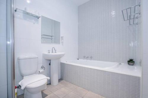 y baño con aseo, bañera y lavamanos. en Escape To Sydney @ Ultimo Unique 2 Bedroom Sleeping 7 City Side en Sídney