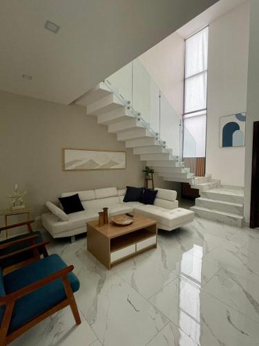 a living room with a couch and a staircase at Casa Santacruz in Ensenada