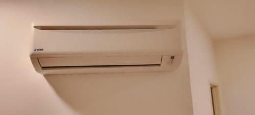 a kitchen with a air conditioner in a room at Seeds Hotel Shah Alam Seksyen 7 I-City in Shah Alam