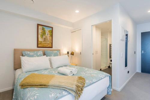 ein Schlafzimmer mit einem großen Bett in einem Zimmer in der Unterkunft CBD Apartment beside Millennium in Auckland