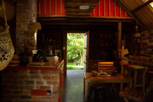 a kitchen with a table and a door into a room at Estancia Iraka in Ráquira