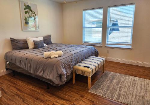 1 dormitorio con 1 cama grande, banco y ventana en Centrally Located 3 Bed Minutes From Downtown, en Houston