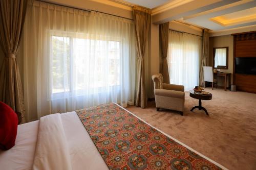 une chambre d'hôtel avec un lit, une chaise et une fenêtre dans l'établissement Hotel Dolmaling, à Katmandou