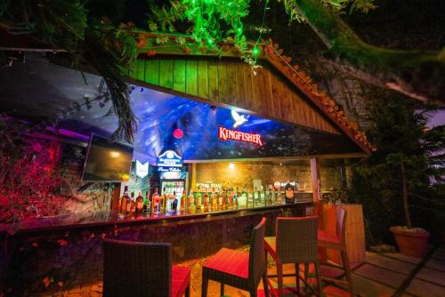 a bar with a bunch of bottles of alcohol at Kasauli Castle Resort in Kasauli