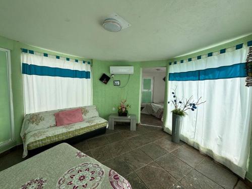 a living room with a couch and a window at Terraza del Lago in Tequesquitengo