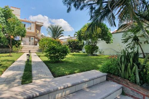a house with a walkway in front of a yard at Terraza del Lago in Tequesquitengo