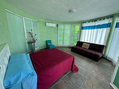 a bedroom with a bed and a couch at Terraza del Lago in Tequesquitengo