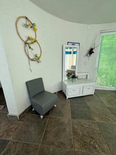 a room with a chair and a mirror on a wall at Terraza del Lago in Tequesquitengo