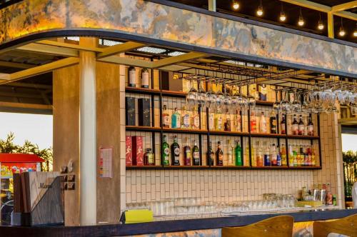 a bar with alcohol bottles on the wall at Blu Hotel in Nakhon Phanom