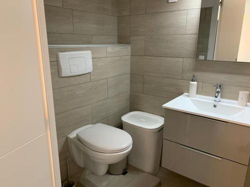 a bathroom with a toilet and a sink at bellucciu di porto vecchio***. (Piscine chauffée) in Porto-Vecchio
