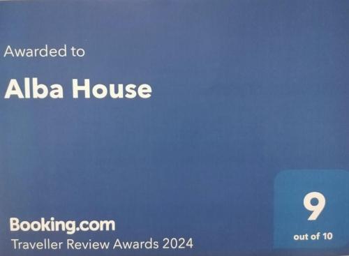 a sign that saysived to albia house and a blue at Alba House in Cuneo