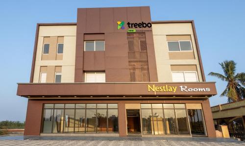 a building with a mexico mercy rooms sign on it at Treebo Trend Nestlay Rooms Gummidipoondi in Chennai