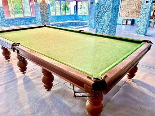 a pool table sitting inside of a room with at Yongogsoy Village in Kyzyldzhar