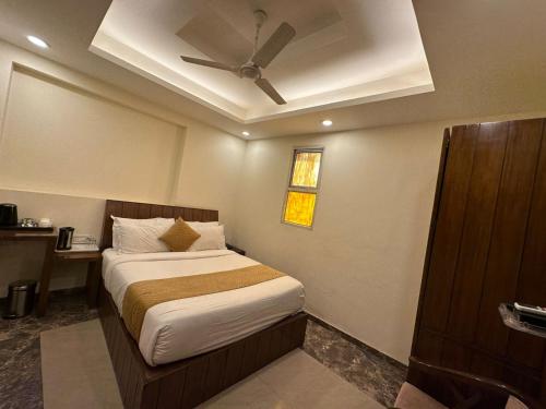 a bedroom with a bed and a ceiling fan at HOTEL BLUE ORCHID - A 3 STAR HEAVEN IN Tricity in Zirakpur