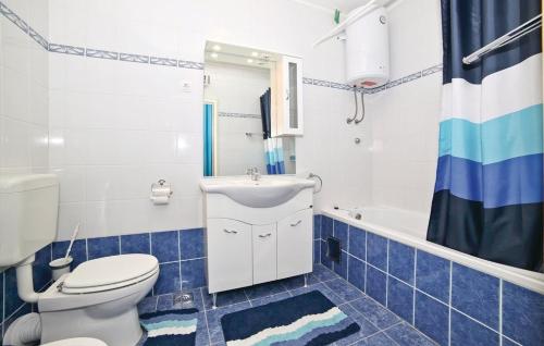 a bathroom with a toilet and a sink and a tub at Apartment Milan - 10 m from the sea in Drvenik Veli