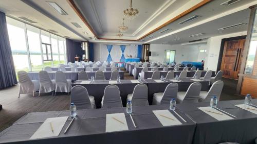 a large room with rows of tables and chairs at Blu Hotel in Nakhon Phanom