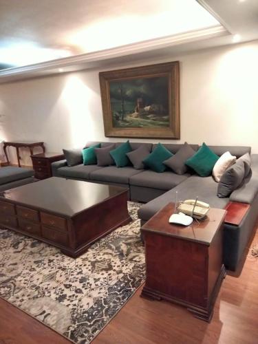 a living room with a couch and a coffee table at شقة الزمالك علي النيل حي السفارات in Cairo