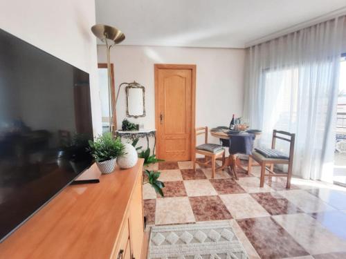 a living room with a television and a checkered floor at Gandia Mallorca 27 in Gandía