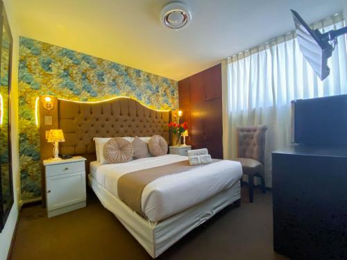 a hotel room with a large bed and a television at AM Hotels Collect in Arequipa