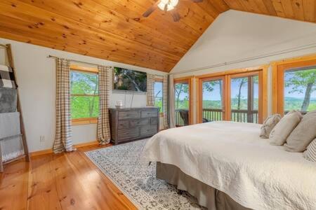 a bedroom with a large bed and a wooden ceiling at Best Views in Ellijay - Waffle Bar-King Bed-HotTub in Ellijay